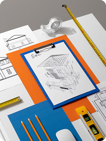 Close-up of project drawings and plans on a workbench