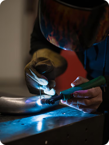 Technician performing precise metal welding repair for Southern Home Handyman